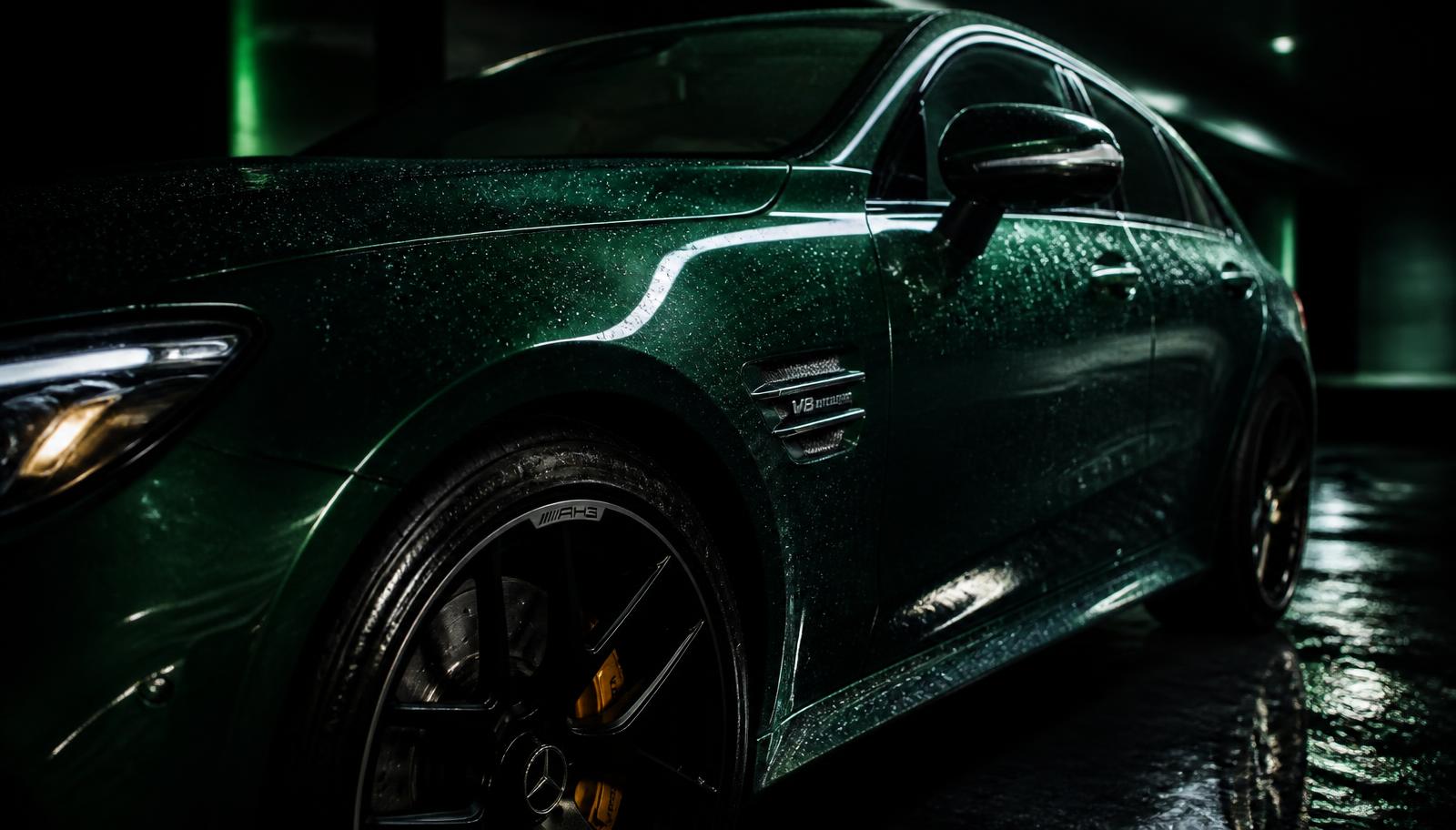 A freshly detailed luxury car with mirror-gloss paint and beading water